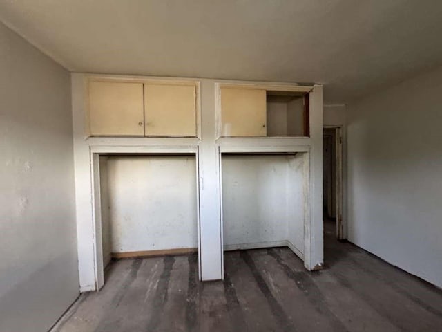 904 E Stanford St, Lubbock, TX 79403 - unfurnished bedroom featuring wood finished floors and two closets