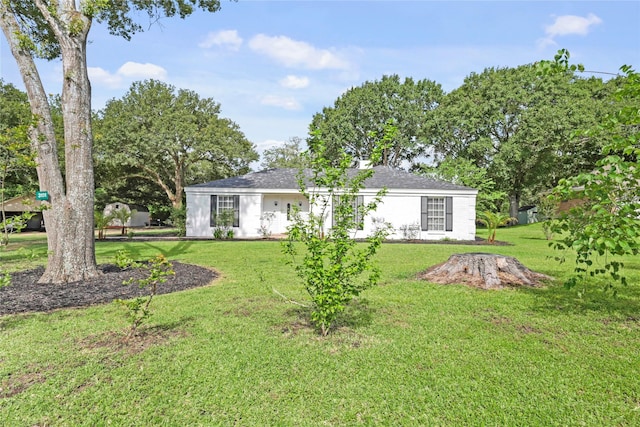 3101 Possum Trot St, Brenham, TX 77833 - back of house with a lawn and a shingled roof