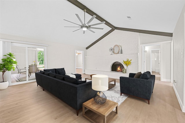 3101 Possum Trot St, Brenham, TX 77833 - living room featuring ceiling fan, light wood finished floors, and a brick fireplace
