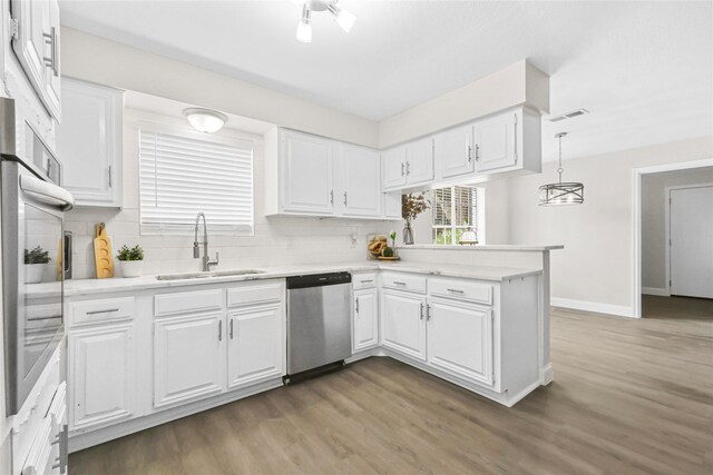 3101 Possum Trot St, Brenham, TX 77833 - kitchen with stainless steel appliances, a peninsula, and white cabinets