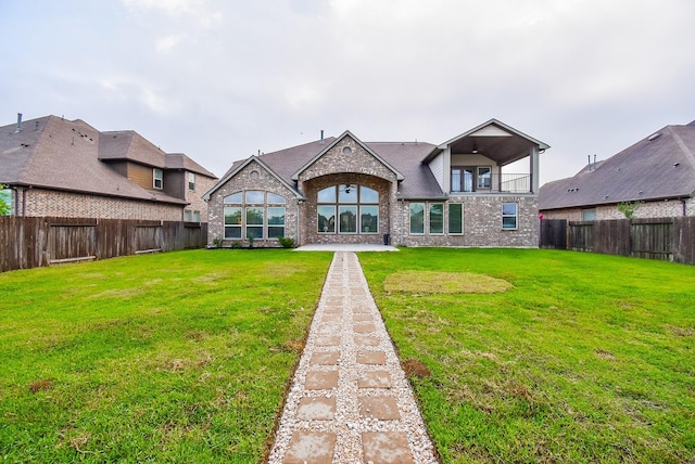 19019 Kimber Creek Ln, Cypress, TX 77429 - back of house with brick siding, a fenced backyard, and a balcony