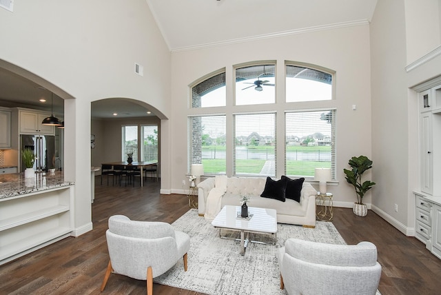 19019 Kimber Creek Ln, Cypress, TX 77429 - living room featuring arched walkways, high vaulted ceiling, crown molding, ceiling fan, and dark wood-type flooring