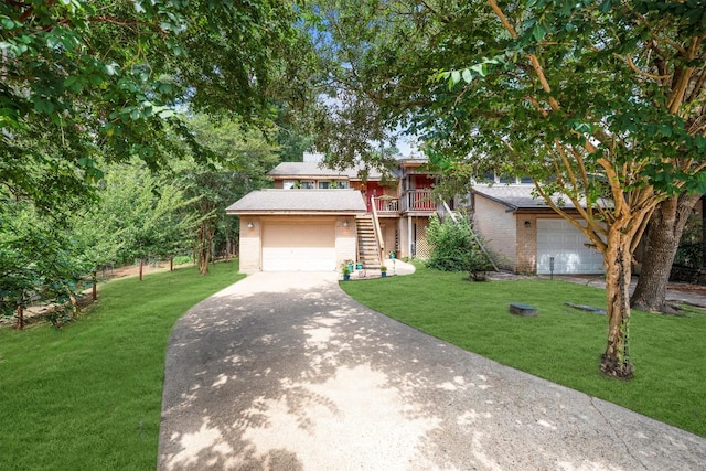 1501 Wimbledon Dr, Huntsville, TX 77340 - view of front facade with stairway, a front yard, brick siding, and concrete driveway