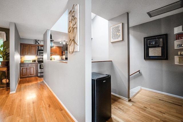 1501 Wimbledon Dr, Huntsville, TX 77340 - corridor with an upstairs landing and light wood-style flooring