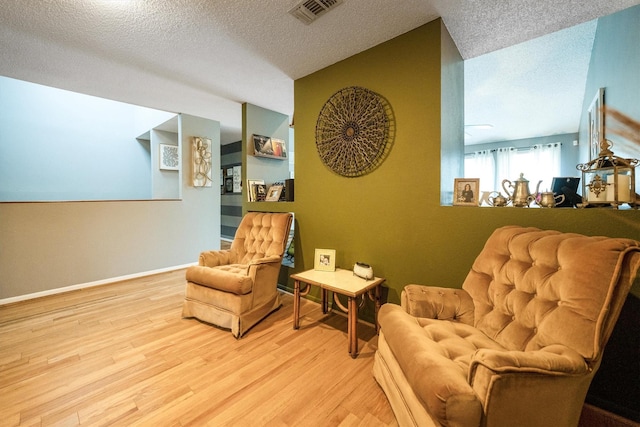 1501 Wimbledon Dr, Huntsville, TX 77340 - sitting room featuring wood finished floors and a textured ceiling