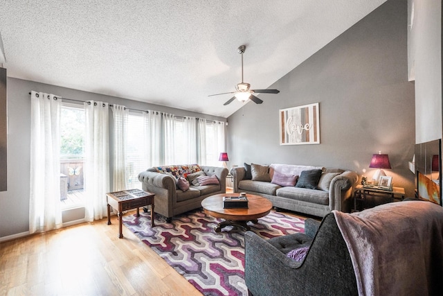 1501 Wimbledon Dr, Huntsville, TX 77340 - living room with light wood-style flooring, lofted ceiling, ceiling fan, and a textured ceiling