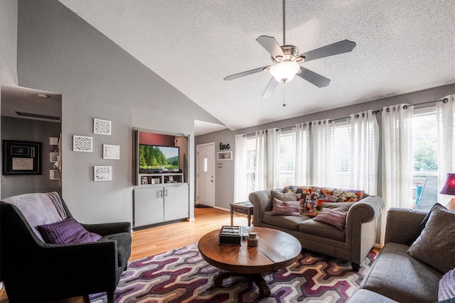 1501 Wimbledon Dr, Huntsville, TX 77340 - living area featuring a textured ceiling, light wood-style flooring, plenty of natural light, a ceiling fan, and high vaulted ceiling