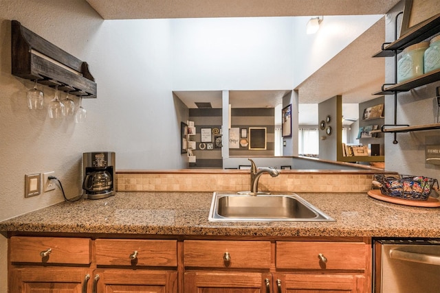 1501 Wimbledon Dr, Huntsville, TX 77340 - kitchen with dishwasher, open shelves, brown cabinetry, and a textured wall