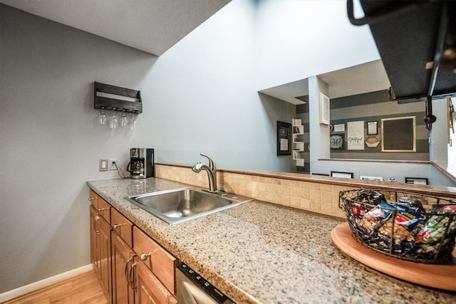 1501 Wimbledon Dr, Huntsville, TX 77340 - kitchen featuring brown cabinets, backsplash, light wood-type flooring, and light countertops