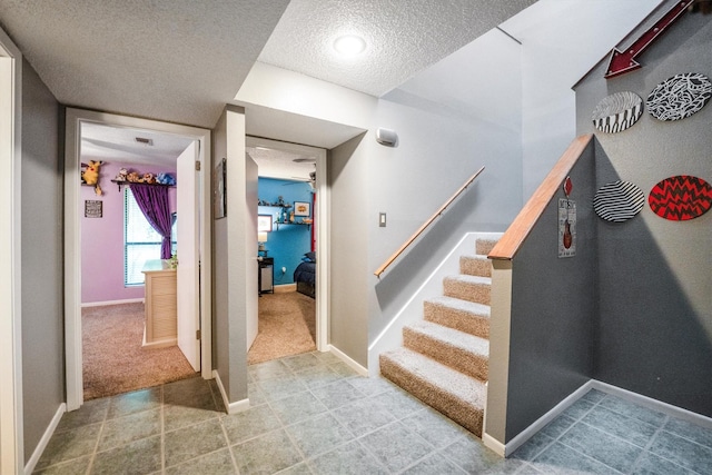 1501 Wimbledon Dr, Huntsville, TX 77340 - stairway with a textured ceiling and carpet floors