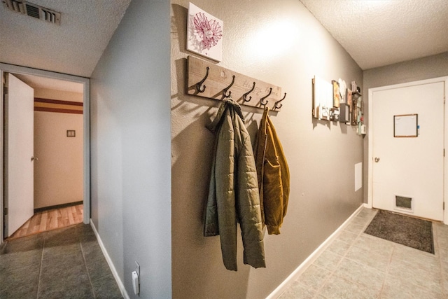 1501 Wimbledon Dr, Huntsville, TX 77340 - mudroom featuring a textured ceiling and tile patterned flooring