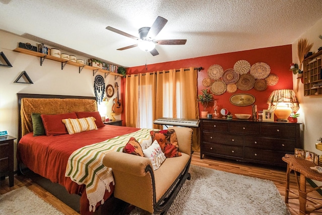 1501 Wimbledon Dr, Huntsville, TX 77340 - bedroom with wood finished floors, a textured ceiling, and ceiling fan