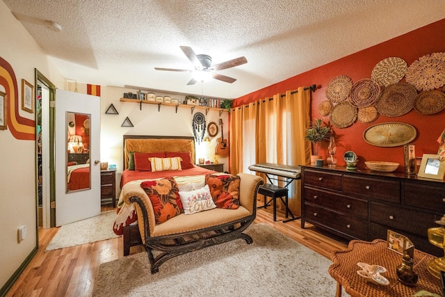 1501 Wimbledon Dr, Huntsville, TX 77340 - bedroom with a textured ceiling, wood finished floors, and a ceiling fan