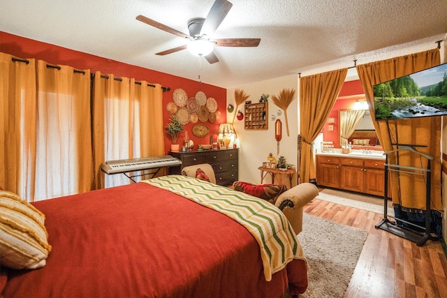1501 Wimbledon Dr, Huntsville, TX 77340 - bedroom with light wood-type flooring, a textured ceiling, and ceiling fan