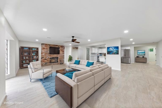 3915 Southmore Cir, Houston, TX 77004 - living area featuring a fireplace, recessed lighting, ceiling fan, and light wood-style flooring