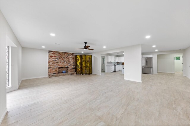 3915 Southmore Cir, Houston, TX 77004 - unfurnished living room with ceiling fan, recessed lighting, light wood-style floors, and a fireplace