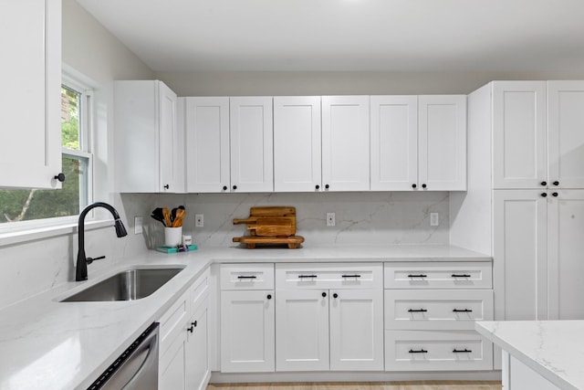 3915 Southmore Cir, Houston, TX 77004 - kitchen with white cabinetry, light stone countertops, and backsplash