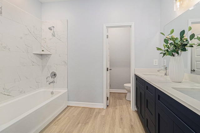 9311 Noel St, Houston, TX 77033 - bathroom with wood finished floors, double vanity, and shower / tub combination