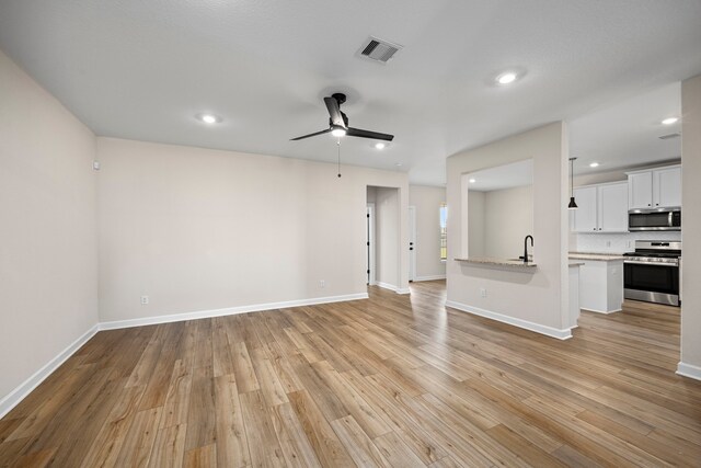 3061 Sorrento Hill Dr, Katy, TX 77493 - unfurnished living room with a ceiling fan, light wood-style flooring, and recessed lighting