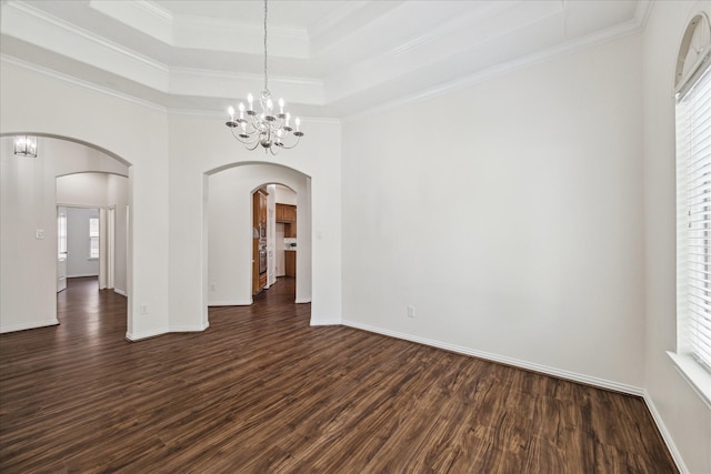 25207 Oak Star Dr, Spring, TX 77389 - spare room featuring a chandelier, dark wood-style floors, plenty of natural light, arched walkways, and crown molding
