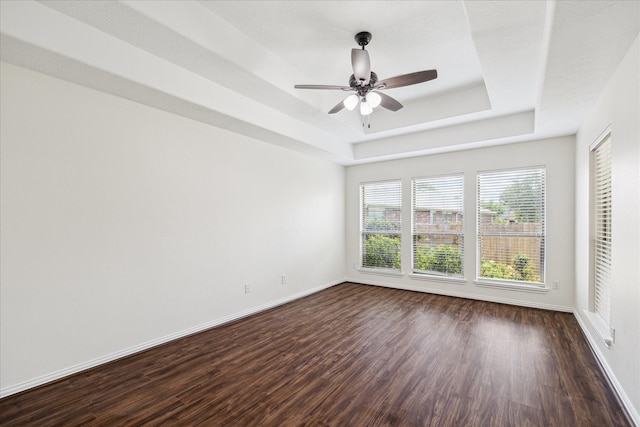 25207 Oak Star Dr, Spring, TX 77389 - empty room featuring a tray ceiling, dark wood finished floors, and ceiling fan