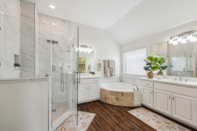 25207 Oak Star Dr, Spring, TX 77389 - full bath with a marble finish shower, wood finished floors, a bath, two vanities, and vaulted ceiling