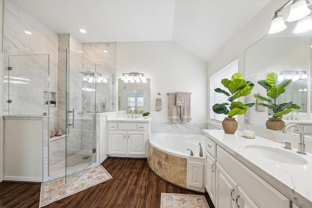 25207 Oak Star Dr, Spring, TX 77389 - full bathroom with a stall shower, wood finished floors, two vanities, a bath, and vaulted ceiling