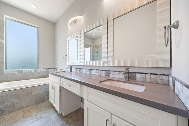 1005 Bingham St Unit 5, Houston, TX 77007 - bathroom featuring double vanity, a bath, a shower stall, tile patterned floors, and tasteful backsplash