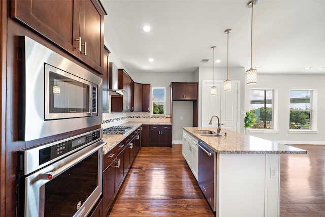 1005 Bingham St Unit 5, Houston, TX 77007 - kitchen with appliances with stainless steel finishes, dark wood finished floors, light stone counters, decorative backsplash, and recessed lighting