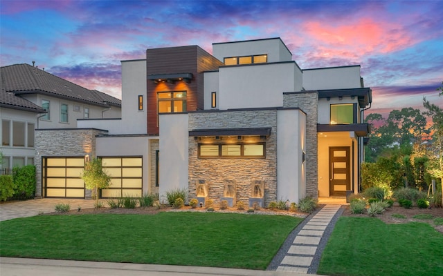 18 Pronghorn Pl, The Woodlands, TX 77389 - modern home featuring stone siding, decorative driveway, and a yard