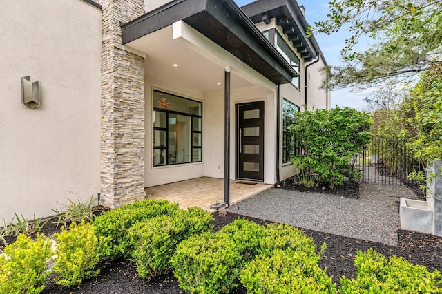 18 Pronghorn Pl, The Woodlands, TX 77389 - property entrance with stucco siding and a patio area