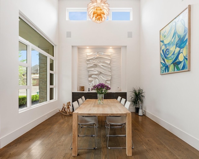 18 Pronghorn Pl, The Woodlands, TX 77389 - dining room featuring healthy amount of natural light, a high ceiling, and dark wood finished floors