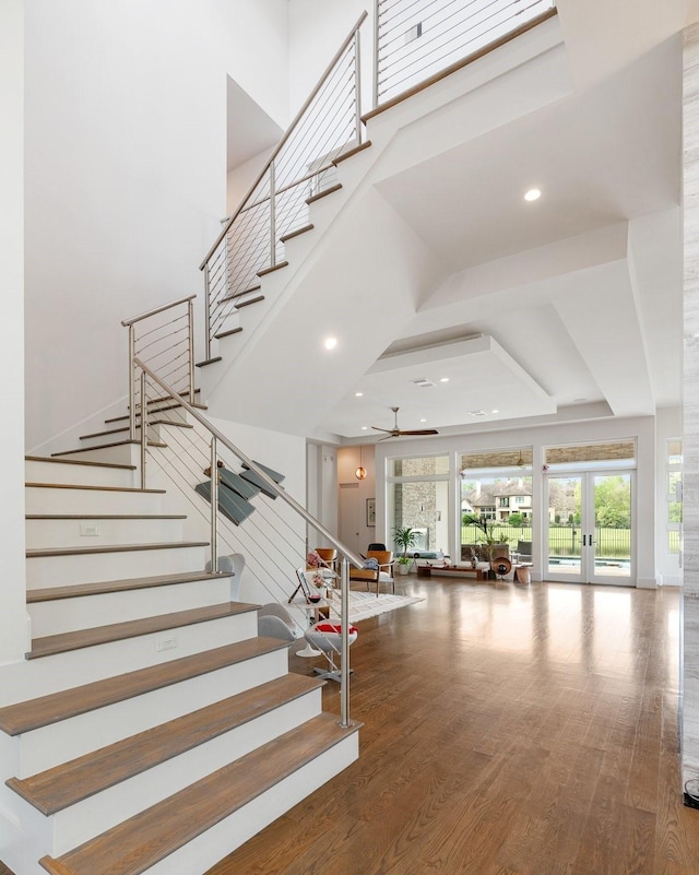 18 Pronghorn Pl, The Woodlands, TX 77389 - stairway with a towering ceiling, ceiling fan, wood finished floors, recessed lighting, and a raised ceiling