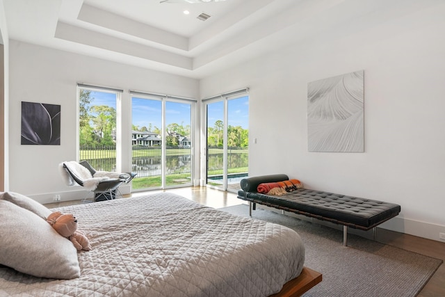 18 Pronghorn Pl, The Woodlands, TX 77389 - bedroom with access to outside, a water view, wood finished floors, and recessed lighting