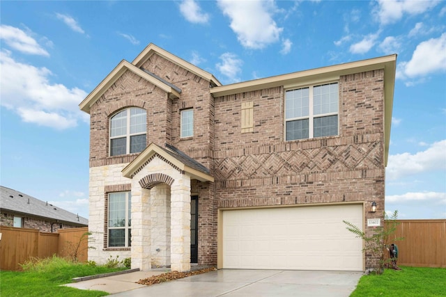13402 Rain Lily, Texas City, TX 77568 - view of front facade with driveway, brick siding, a garage, and stone siding