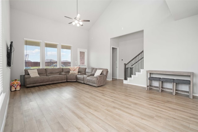 13402 Rain Lily, Texas City, TX 77568 - living room with ceiling fan, light wood finished floors, stairway, and high vaulted ceiling