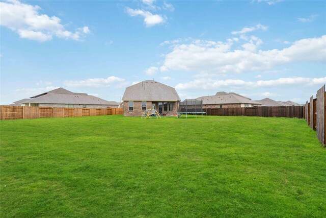 13402 Rain Lily, Texas City, TX 77568 - fenced backyard featuring a trampoline