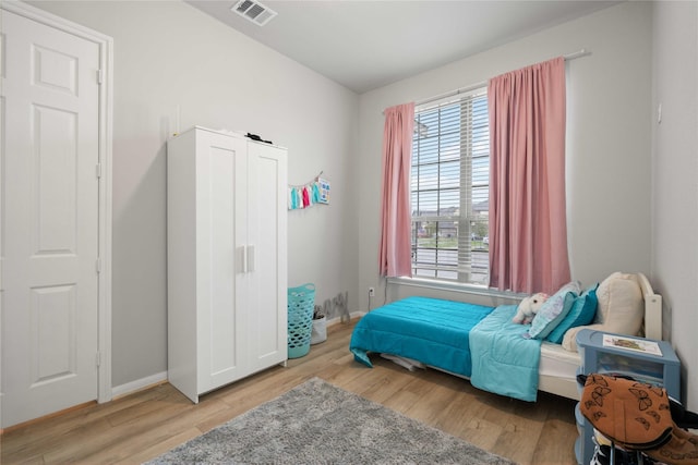 13402 Rain Lily, Texas City, TX 77568 - bedroom featuring multiple windows and wood finished floors