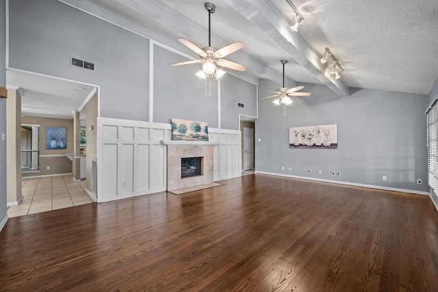 1406 Diana Ct, Houston, TX 77062 - unfurnished living room with track lighting, a ceiling fan, high vaulted ceiling, wood finished floors, and a tile fireplace