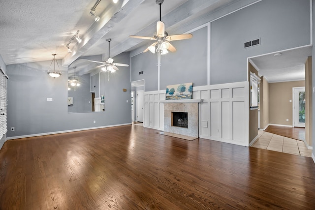 1406 Diana Ct, Houston, TX 77062 - unfurnished living room featuring ceiling fan, a tiled fireplace, wood finished floors, high vaulted ceiling, and beam ceiling