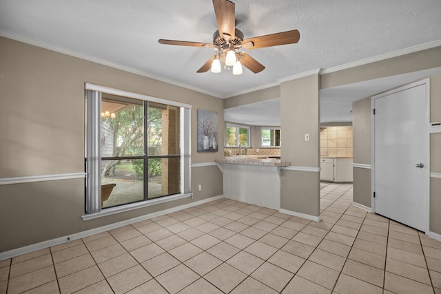 1406 Diana Ct, Houston, TX 77062 - kitchen featuring ceiling fan, a peninsula, light tile patterned floors, ornamental molding, and light countertops