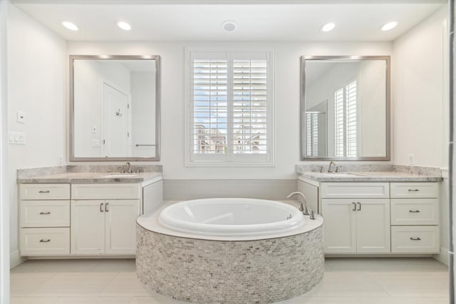 1206 Lake Pointe Pkwy, Sugar Land, TX 77478 - bathroom with plenty of natural light, a garden tub, two vanities, and recessed lighting