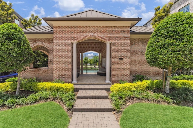 1206 Lake Pointe Pkwy, Sugar Land, TX 77478 - entrance to property featuring a standing seam roof, a metal roof, and brick siding