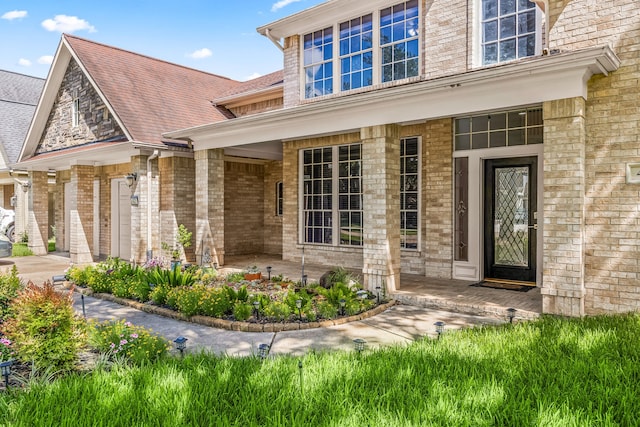 427 Crestwater Trl, Houston, TX 77082 - view of exterior entry with a porch and brick siding