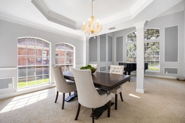 427 Crestwater Trl, Houston, TX 77082 - dining space featuring carpet, a chandelier, crown molding, decorative columns, and a tray ceiling