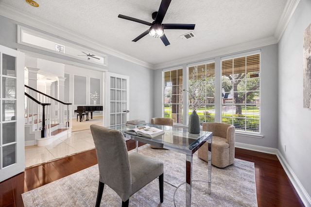 427 Crestwater Trl, Houston, TX 77082 - dining area with ornamental molding, a ceiling fan, stairway, decorative columns, and wood finished floors