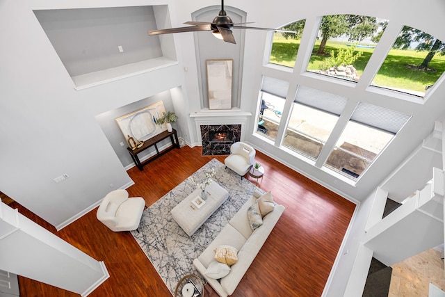 427 Crestwater Trl, Houston, TX 77082 - living area with a towering ceiling, a fireplace, wood finished floors, and ceiling fan