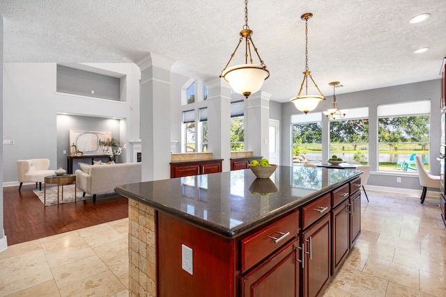 427 Crestwater Trl, Houston, TX 77082 - kitchen with dark brown cabinets, a textured ceiling, a kitchen island, pendant lighting, and recessed lighting