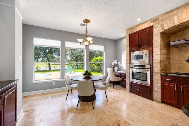 427 Crestwater Trl, Houston, TX 77082 - dining room featuring stone tile flooring, a textured ceiling, a chandelier, and recessed lighting