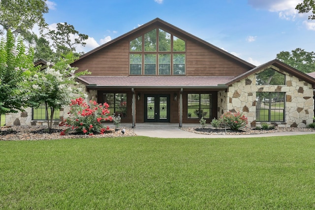 28540 Lynnwood Ln, Hempstead, TX 77445 - back of house with french doors, stone siding, a lawn, and a shingled roof
